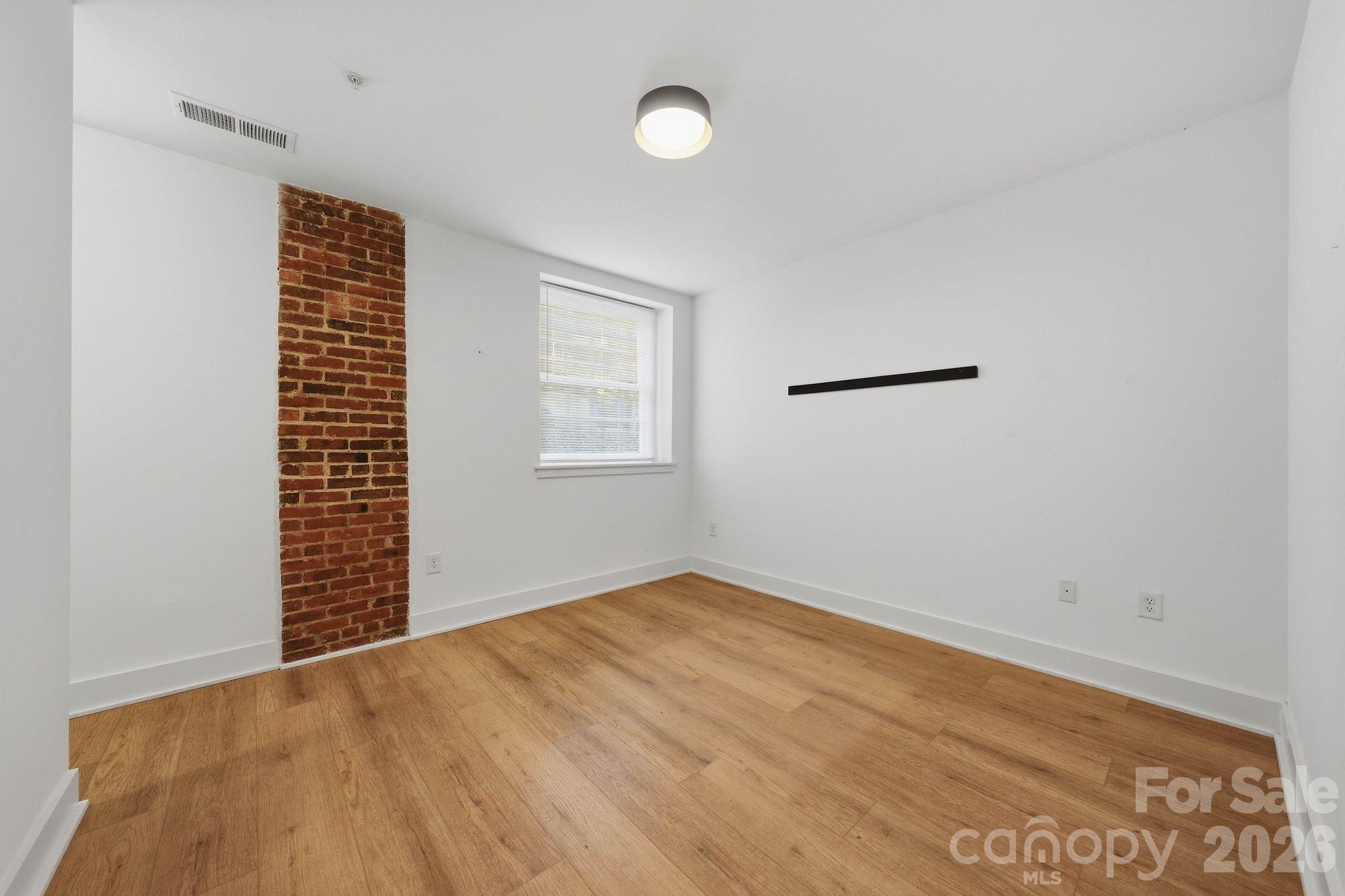 201 Grandin Road, Unit 13 Charlotte, NC 28208 - Photo 24 of 46 an empty room with windows