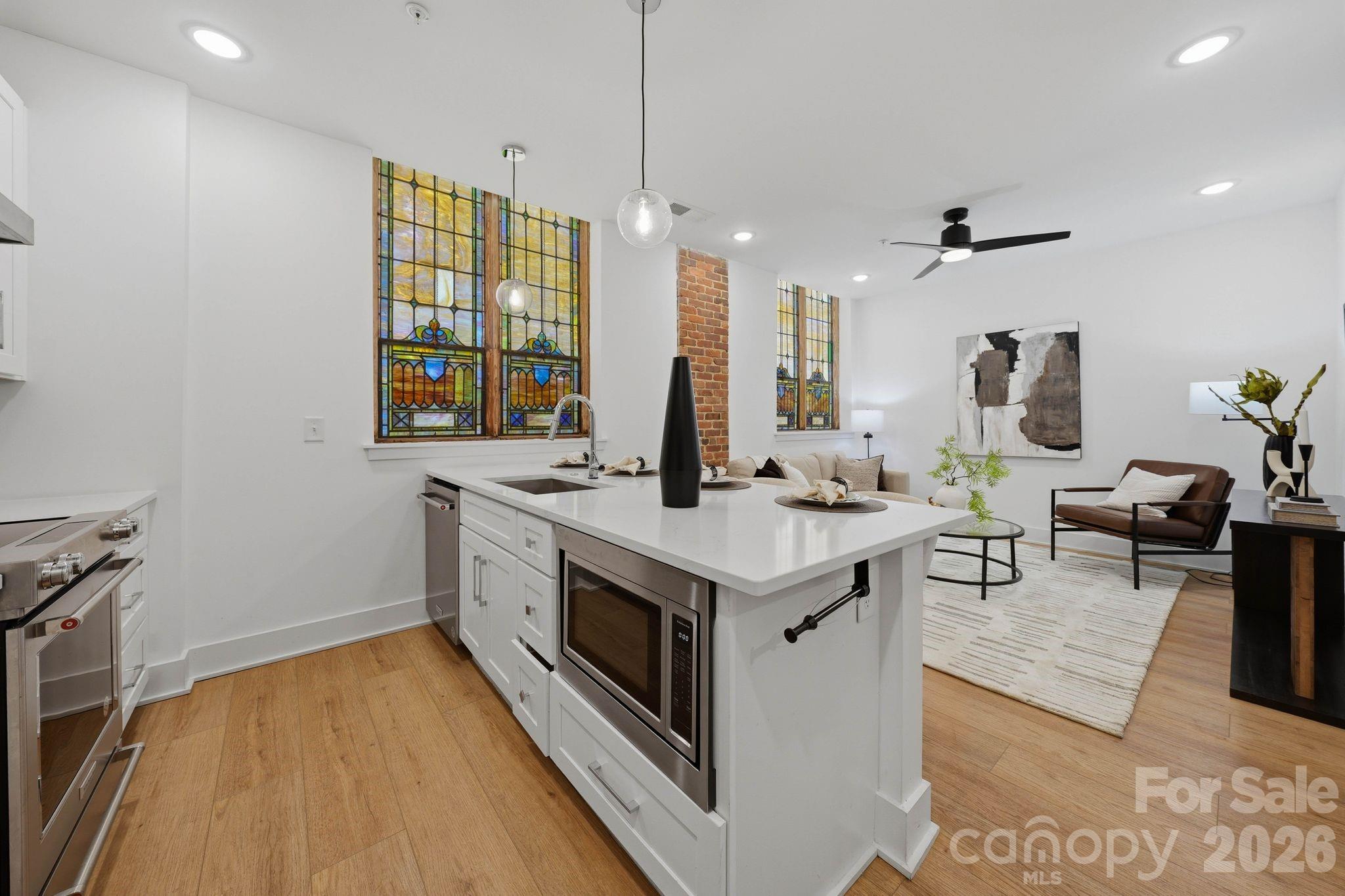 201 Grandin Road, Unit 13 Charlotte, NC 28208 - Photo 9 of 46 a kitchen with a sink stove and wooden floor