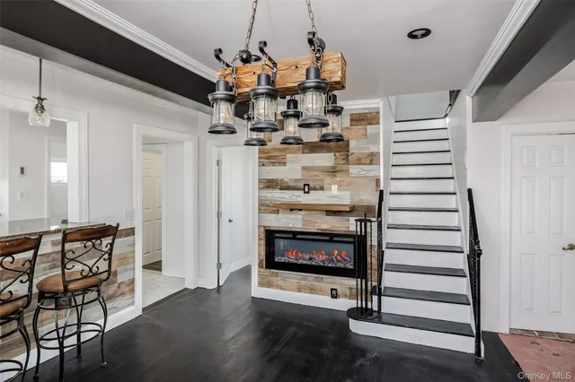 a view of a livingroom with furniture wooden floor and windows
