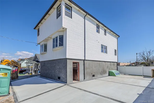 a view of a house with a big yard and sitting area