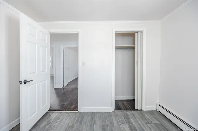 an empty room with wooden floor and closet