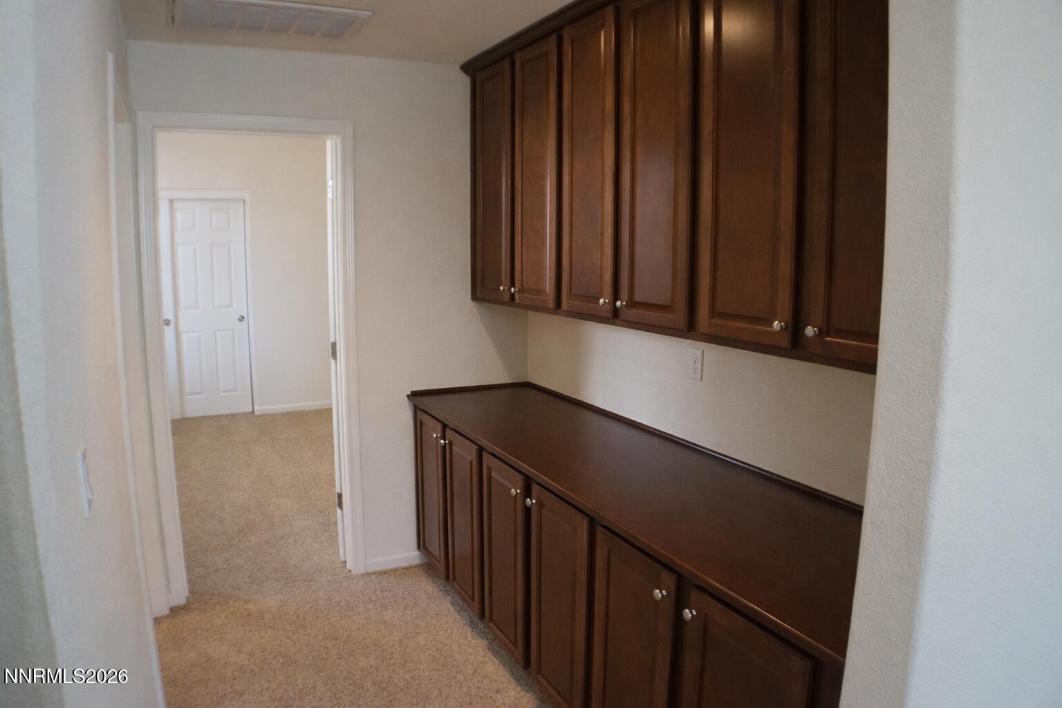10855 Pebble Hill Drive Reno, NV 89521 - Photo 11 of 27 a kitchen with a refrigerator and cabinets
