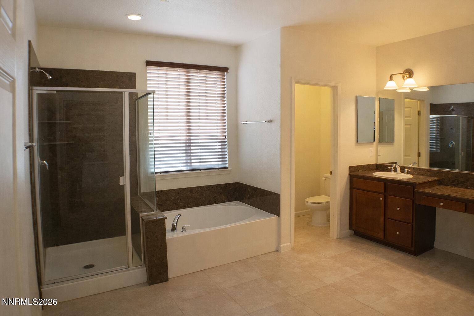 10855 Pebble Hill Drive Reno, NV 89521 - Photo 13 of 27 a bathroom with a bathtub and a shower
