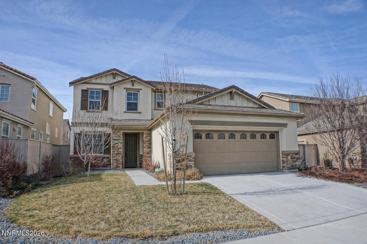 10855 Pebble Hill Drive Reno, NV 89521 - Photo 2 of 27 a front view of a house with garden