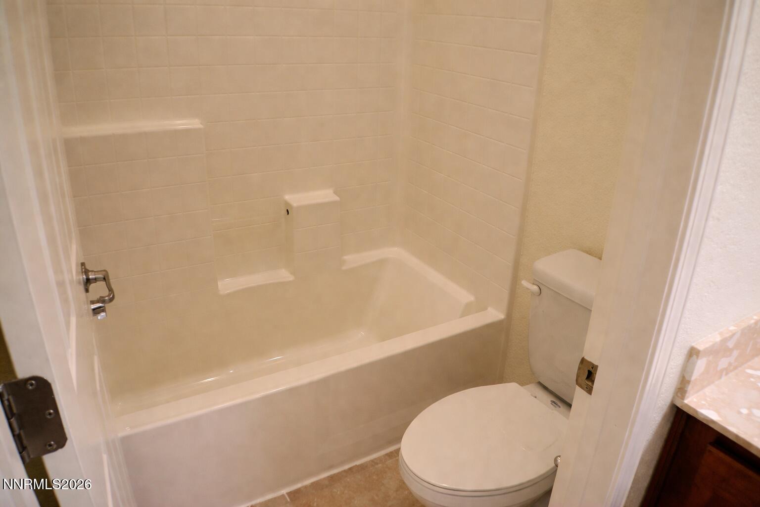 10855 Pebble Hill Drive Reno, NV 89521 - Photo 22 of 27 a white toilet sitting next to a bath tub
