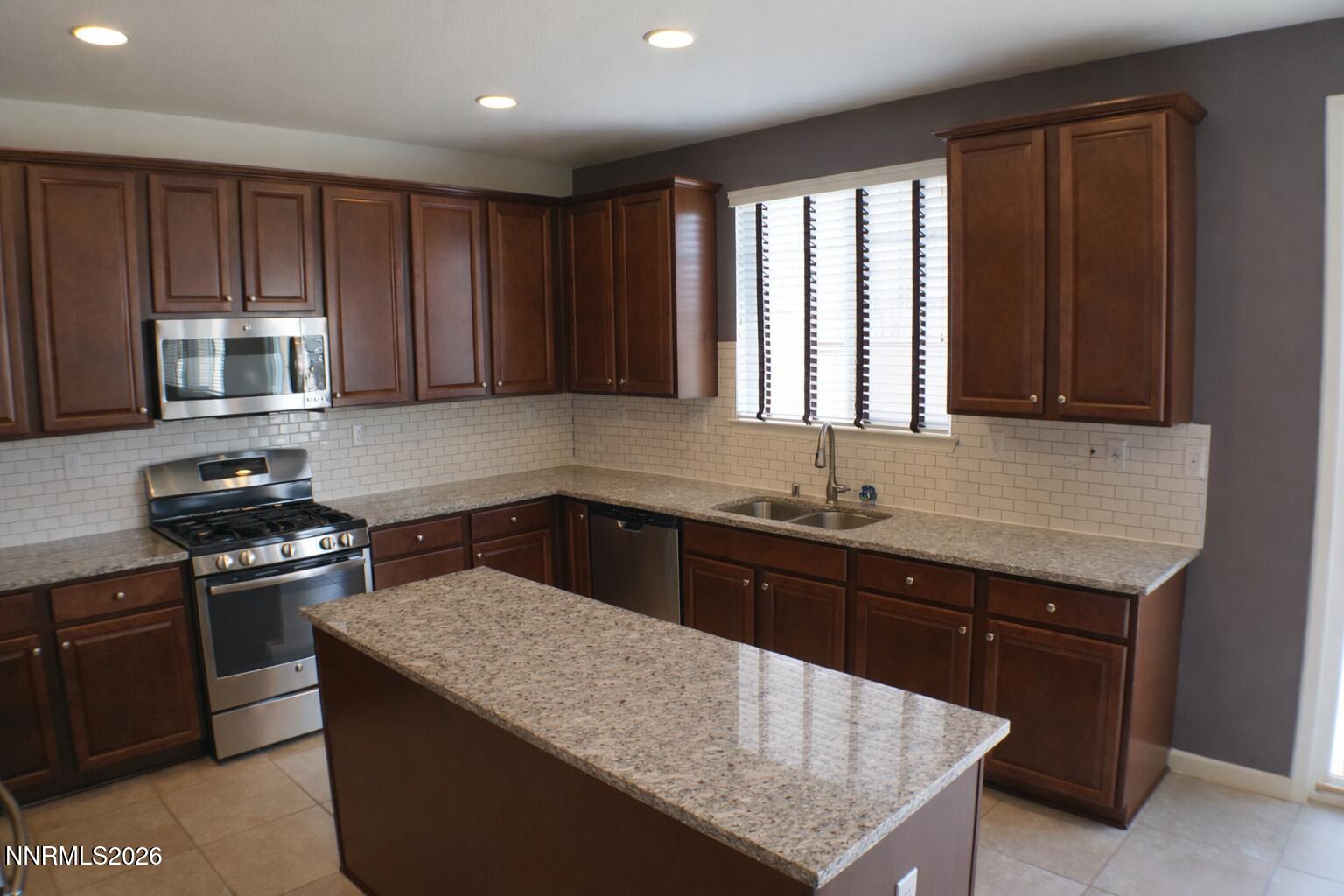10855 Pebble Hill Drive Reno, NV 89521 - Photo 5 of 27 a kitchen with a stove sink and microwave
