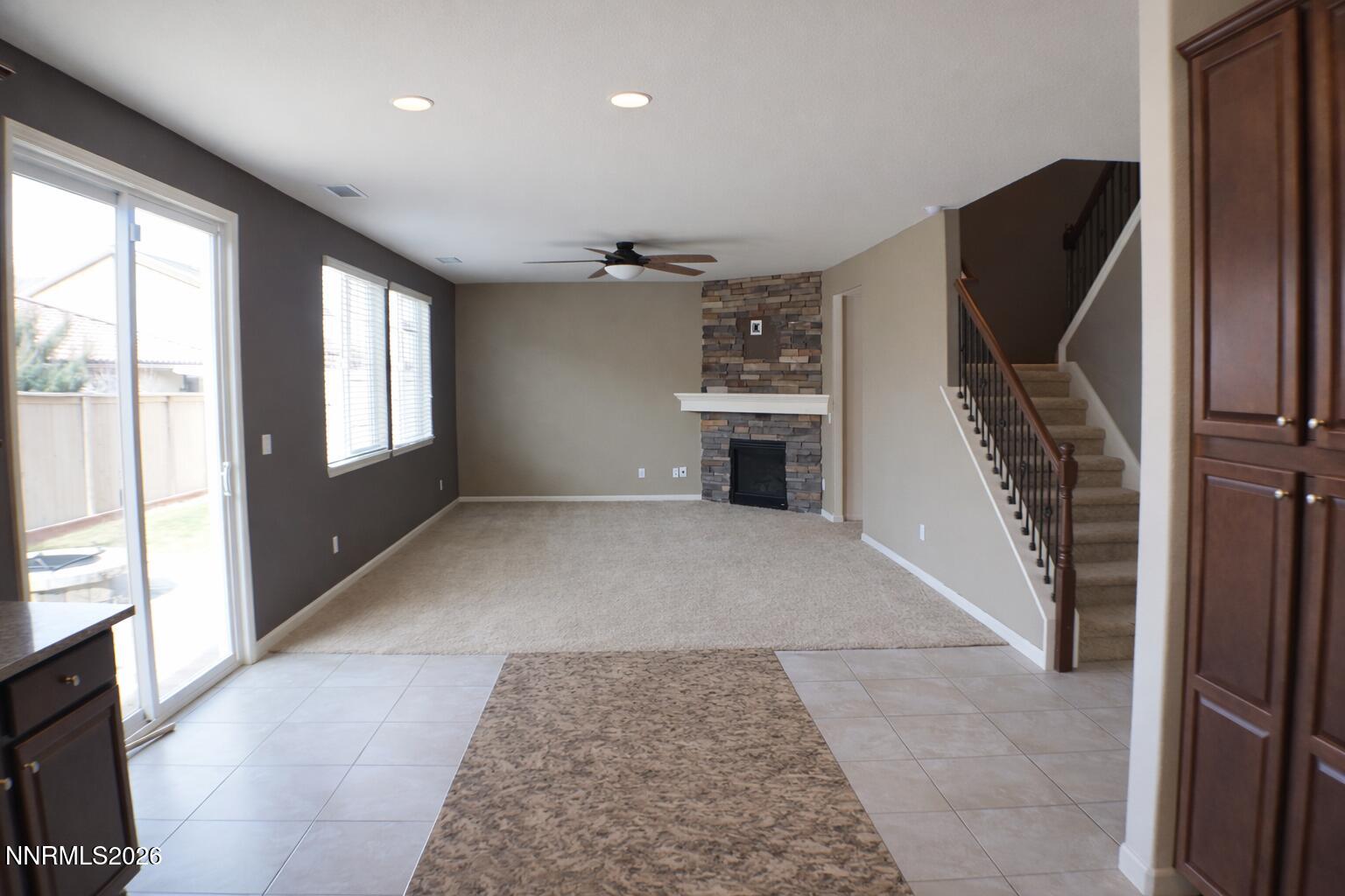 10855 Pebble Hill Drive Reno, NV 89521 - Photo 8 of 27 a view of an empty room with a fireplace and a window