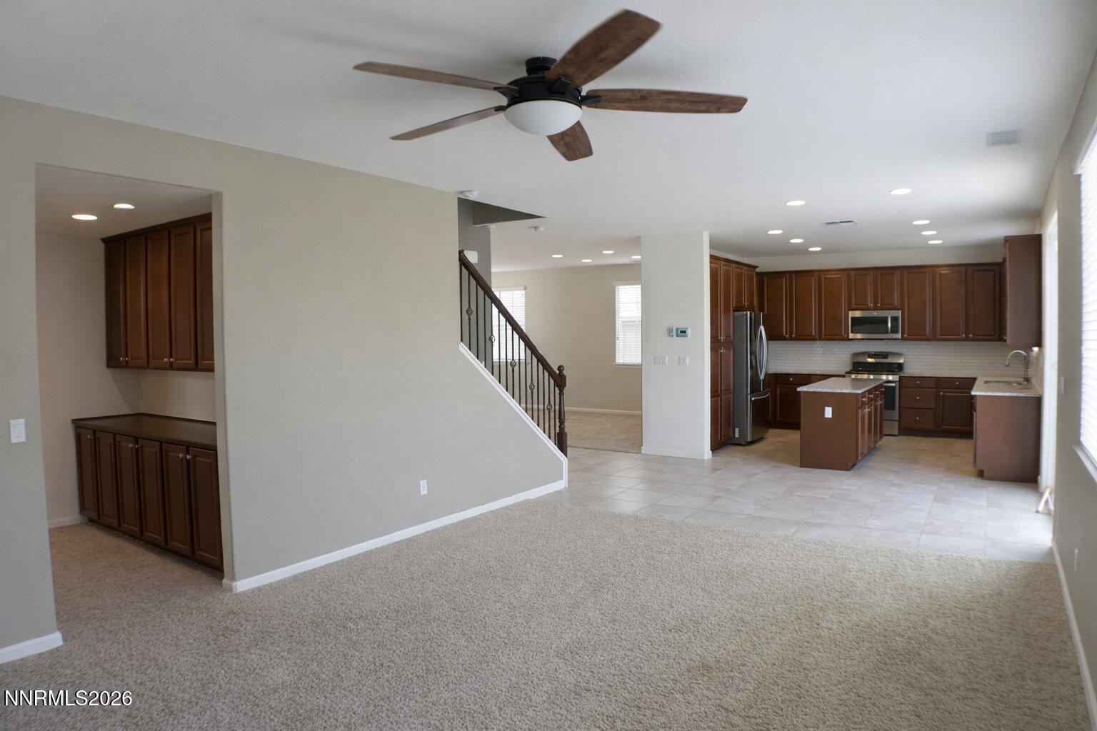 10855 Pebble Hill Drive Reno, NV 89521 - Photo 9 of 27 a view of a kitchen with a sink and a refrigerator