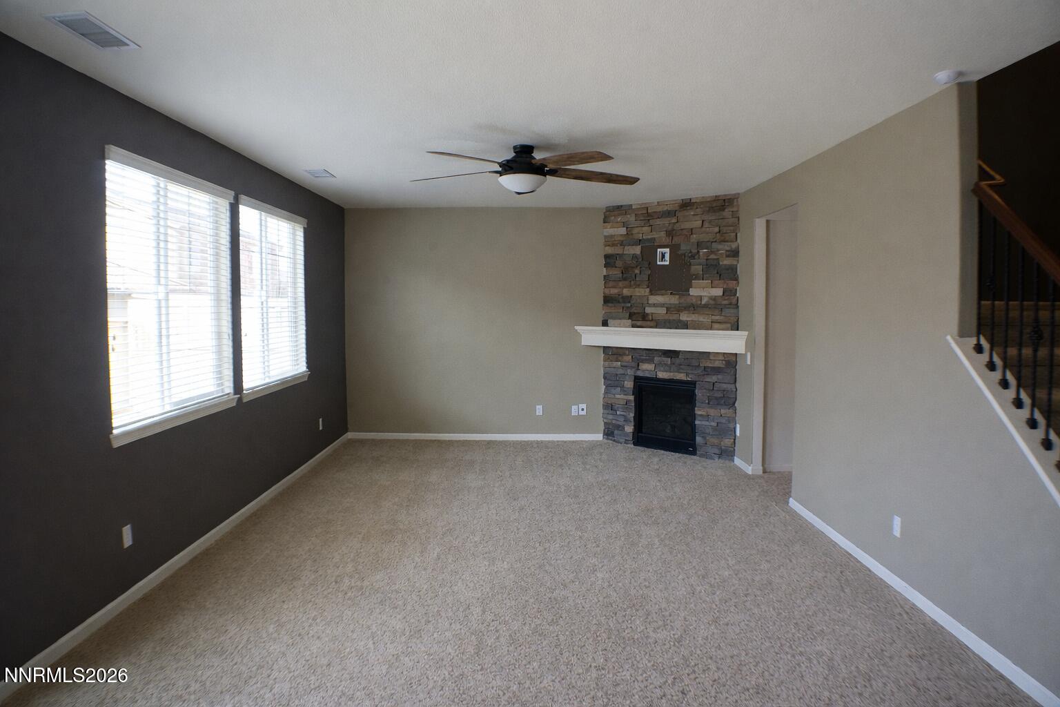 10855 Pebble Hill Drive Reno, NV 89521 - Photo 10 of 27 a view of an empty room with a window and fireplace