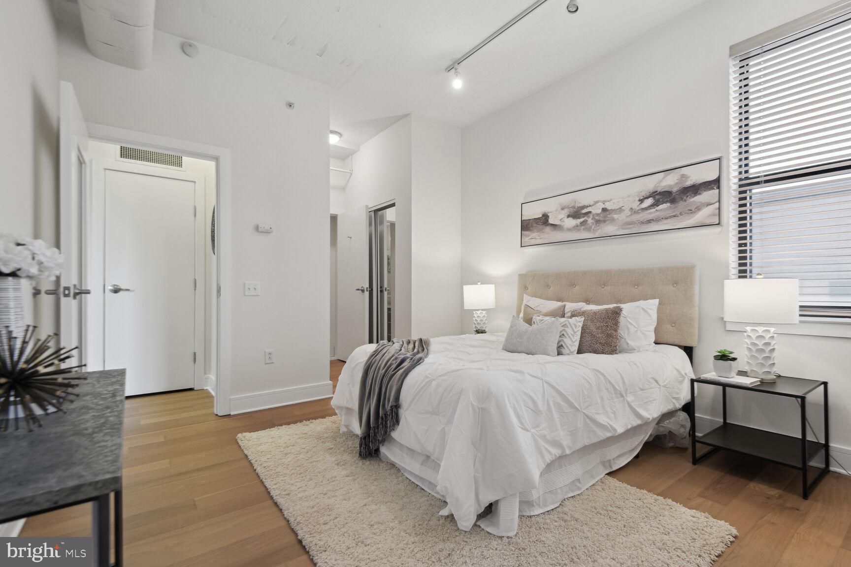 809 6th Street Northwest, Unit 65 Washington, DC 20001 - Photo 11 of 21 a bedroom with a bed a mirror and a potted plant