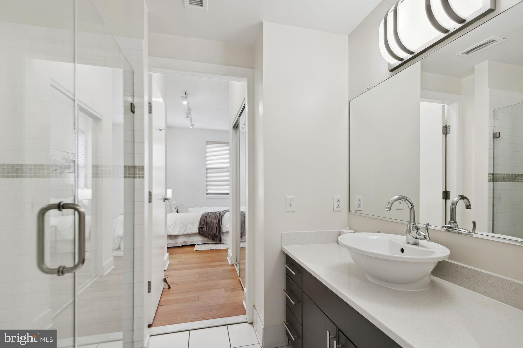809 6th Street Northwest, Unit 65 Washington, DC 20001 - Photo 14 of 21 a bathroom with a sink and mirror with bathtub