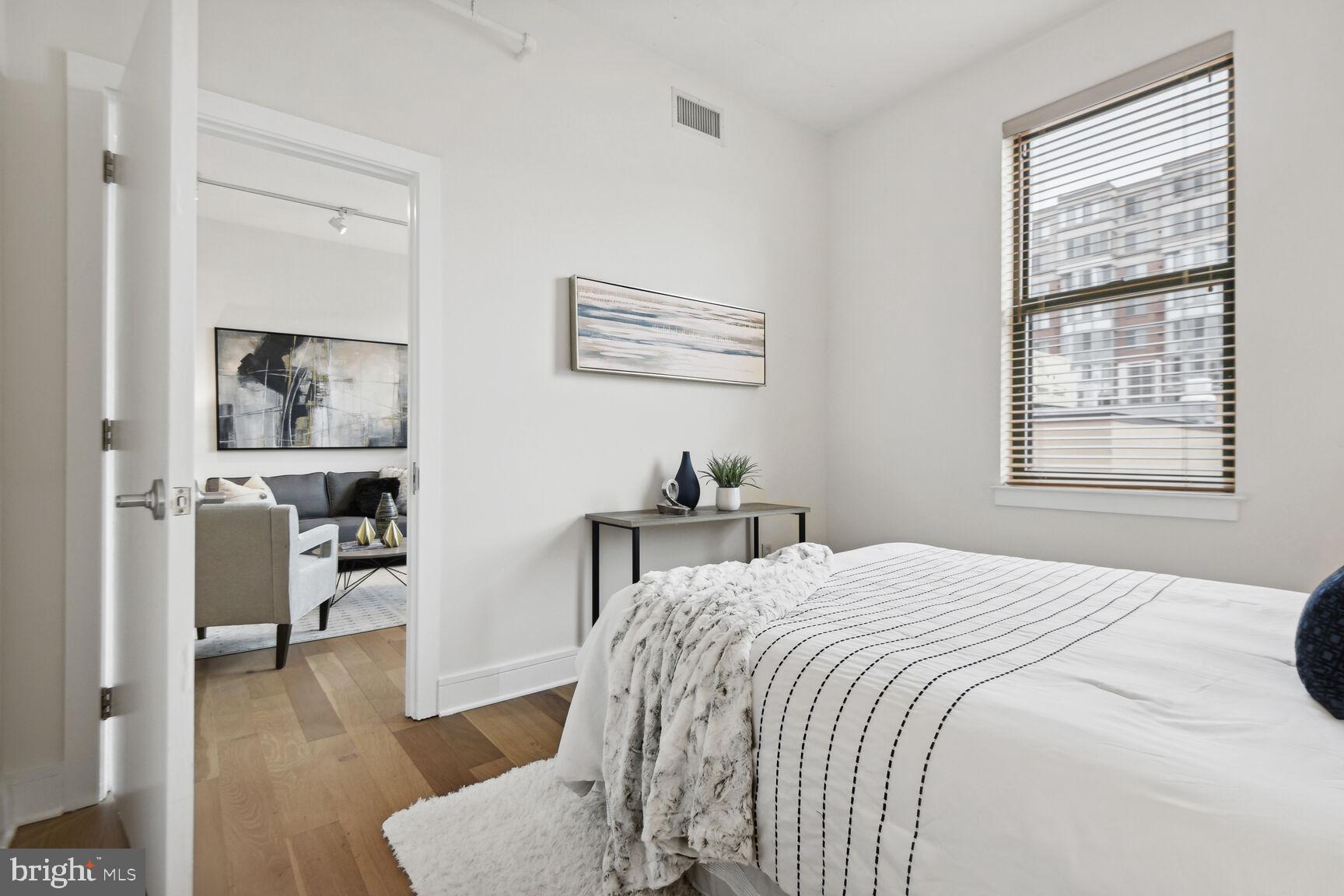 809 6th Street Northwest, Unit 65 Washington, DC 20001 - Photo 16 of 21 a bedroom with a bed and wooden floor