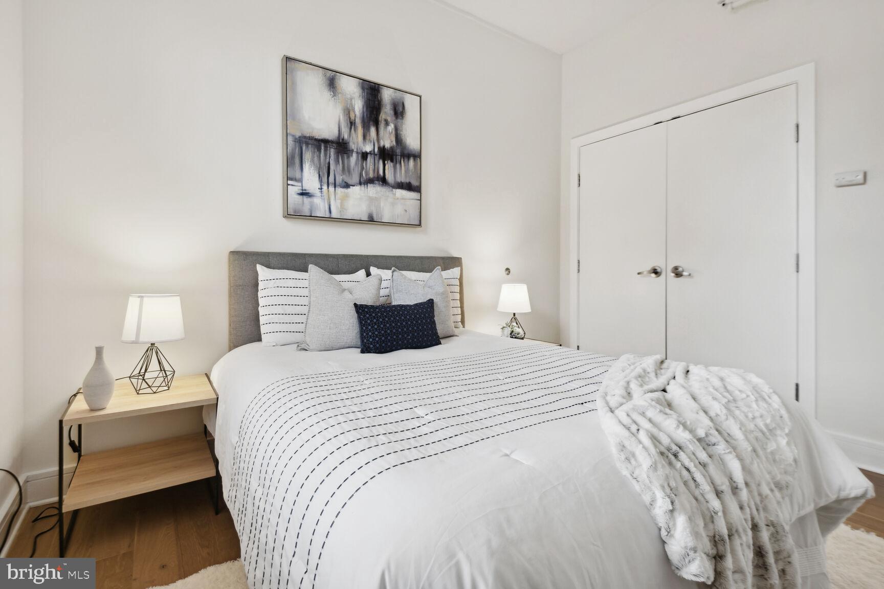 809 6th Street Northwest, Unit 65 Washington, DC 20001 - Photo 17 of 21 a bedroom with bed and painting on the wall