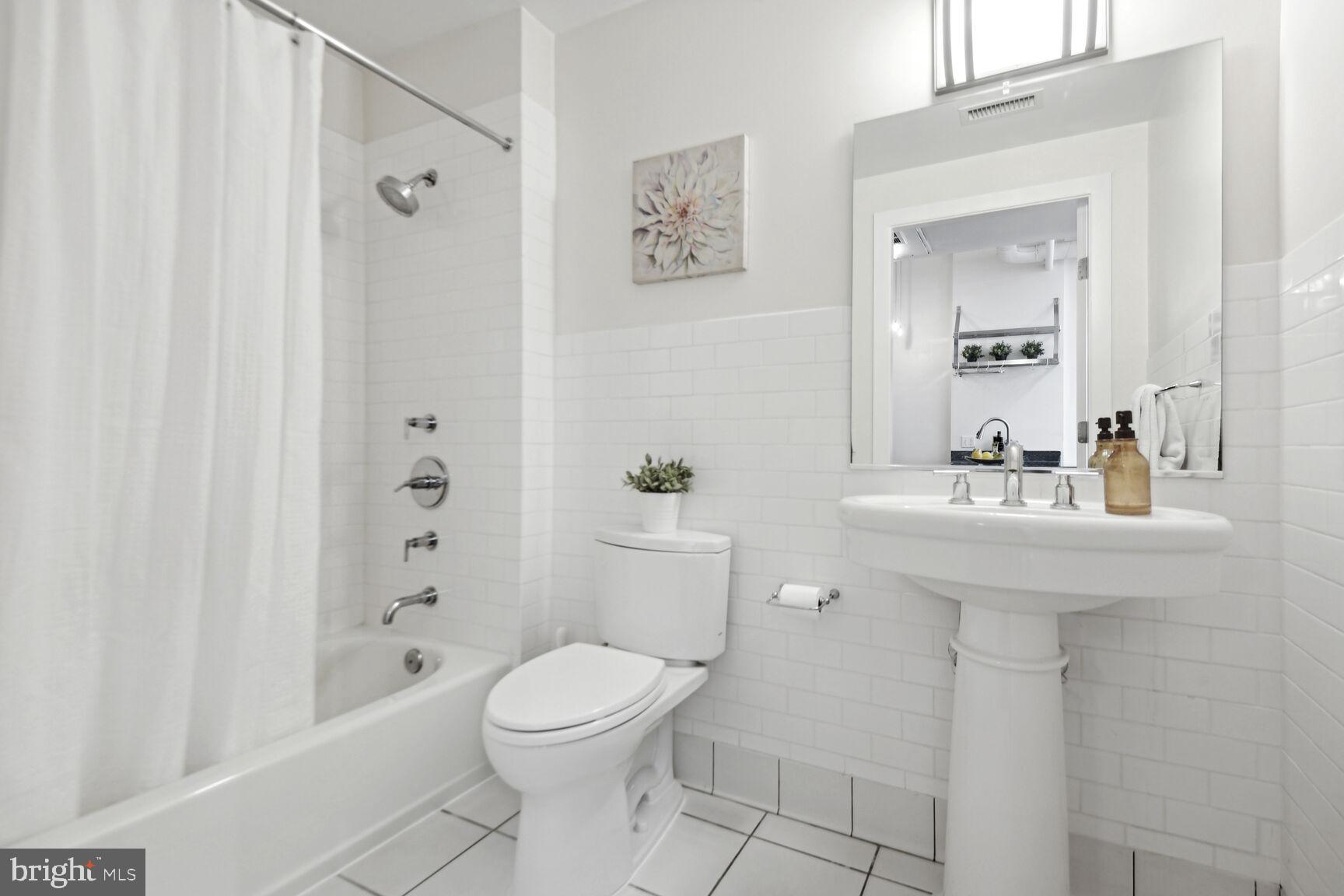 809 6th Street Northwest, Unit 65 Washington, DC 20001 - Photo 18 of 21 a bathroom with a sink a toilet and shower