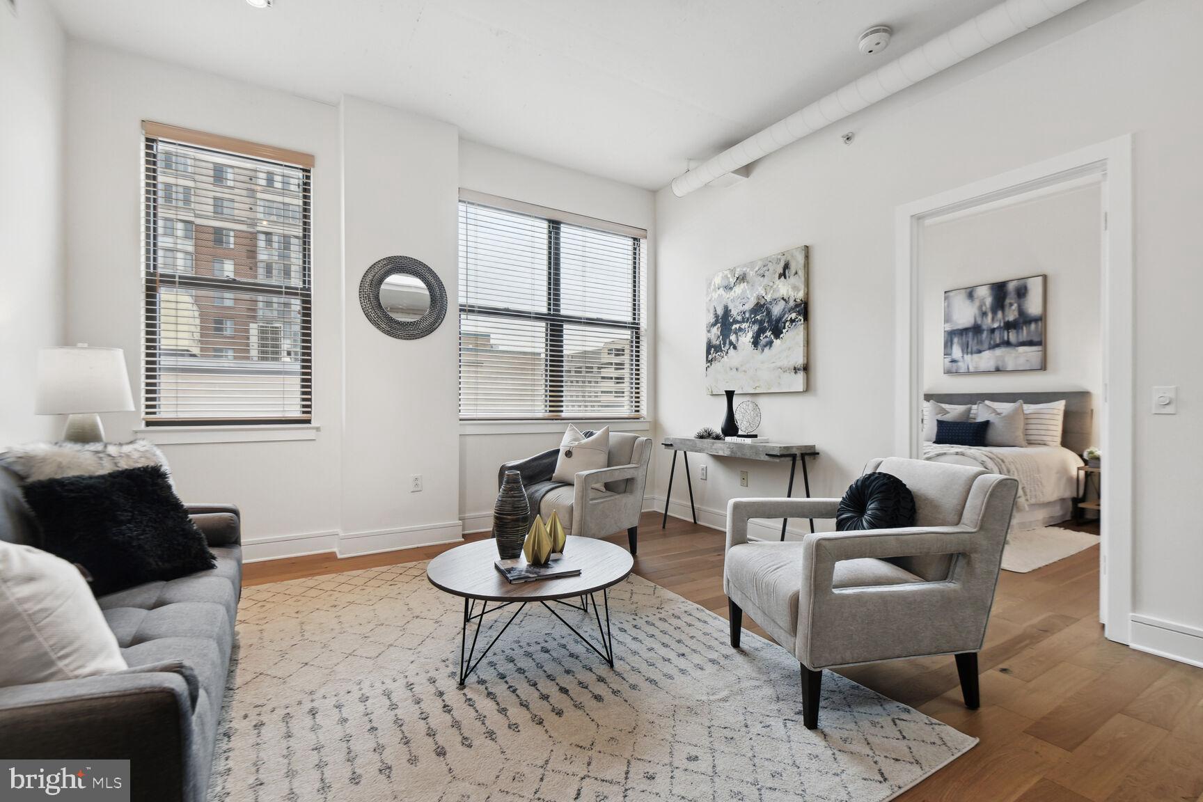 809 6th Street Northwest, Unit 65 Washington, DC 20001 - Photo 2 of 21 a living room with furniture a table and a window