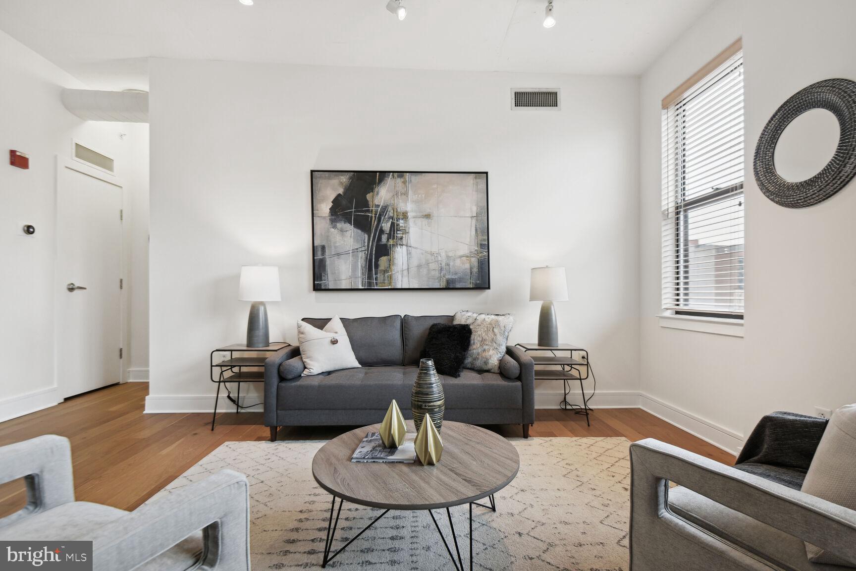 809 6th Street Northwest, Unit 65 Washington, DC 20001 - Photo 3 of 21 a living room with furniture and a window