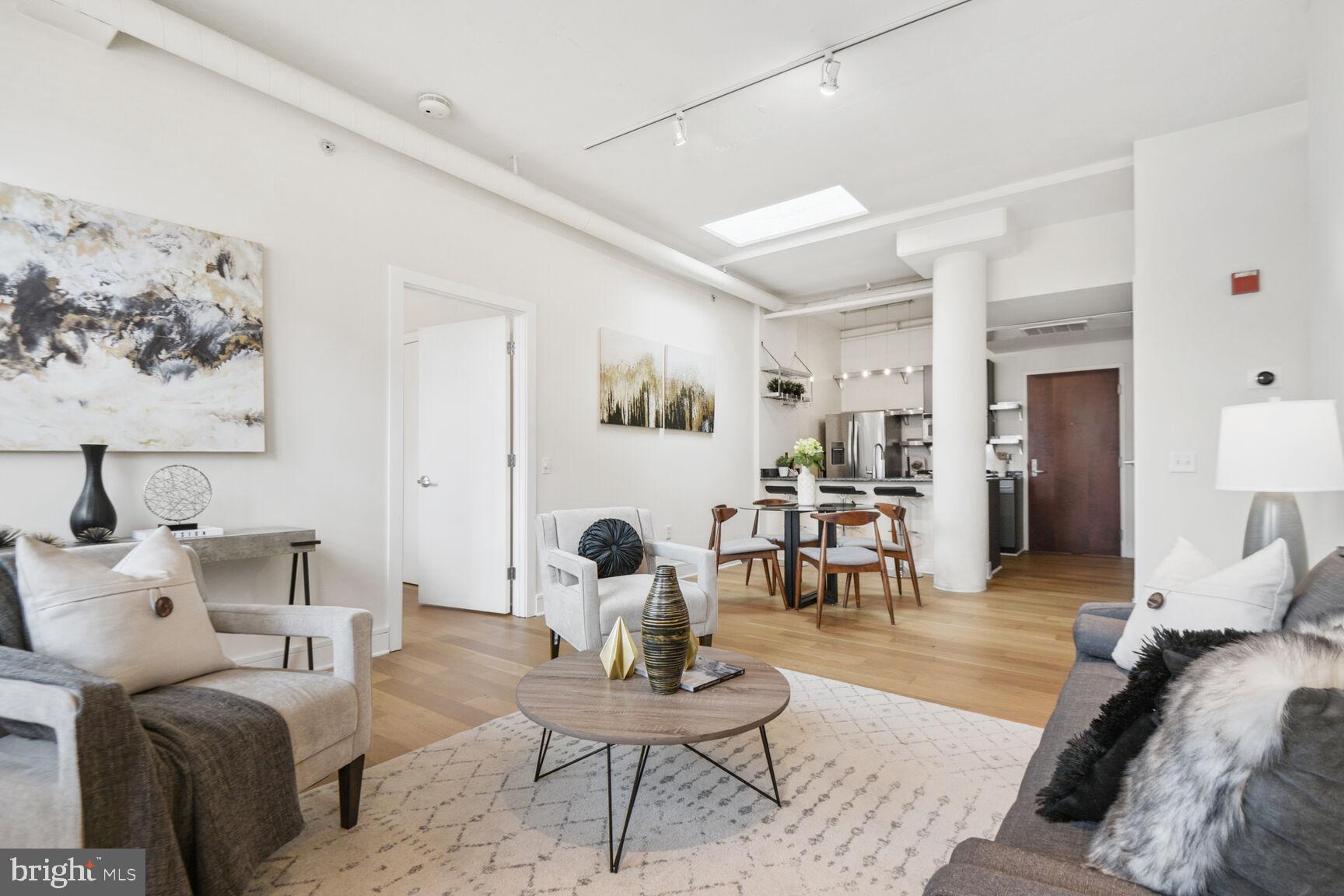 809 6th Street Northwest, Unit 65 Washington, DC 20001 - Photo 4 of 21 a living room with furniture and wooden floor