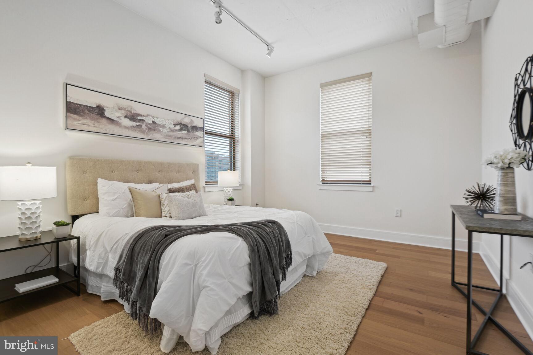 809 6th Street Northwest, Unit 65 Washington, DC 20001 - Photo 10 of 21 a bedroom with a bed and wooden floor