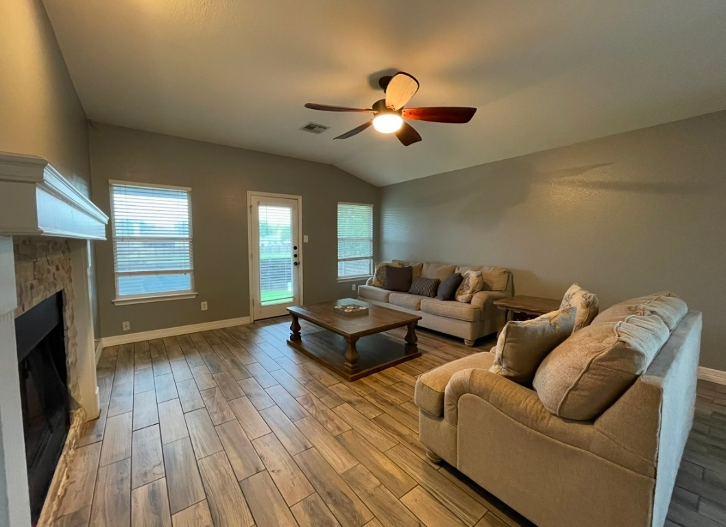 a living room with furniture and a fireplace