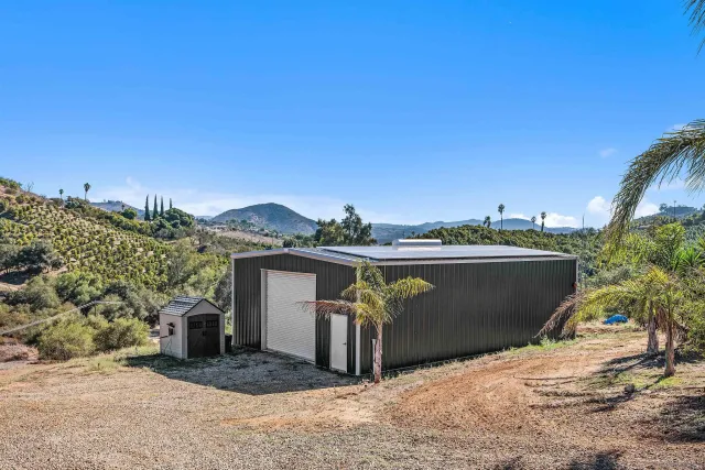 a view of a house with backyard and sitting area