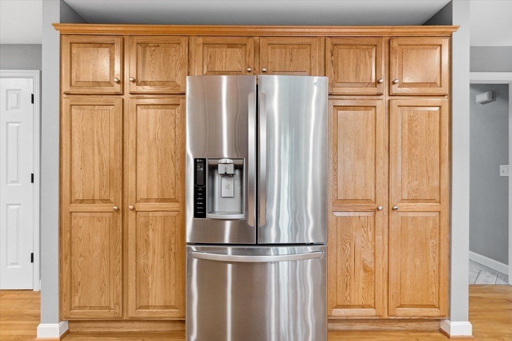 10 Fieldstone Way Boxford, MA 01921 - Photo 11 of 42 a view of a refrigerator with wooden floor