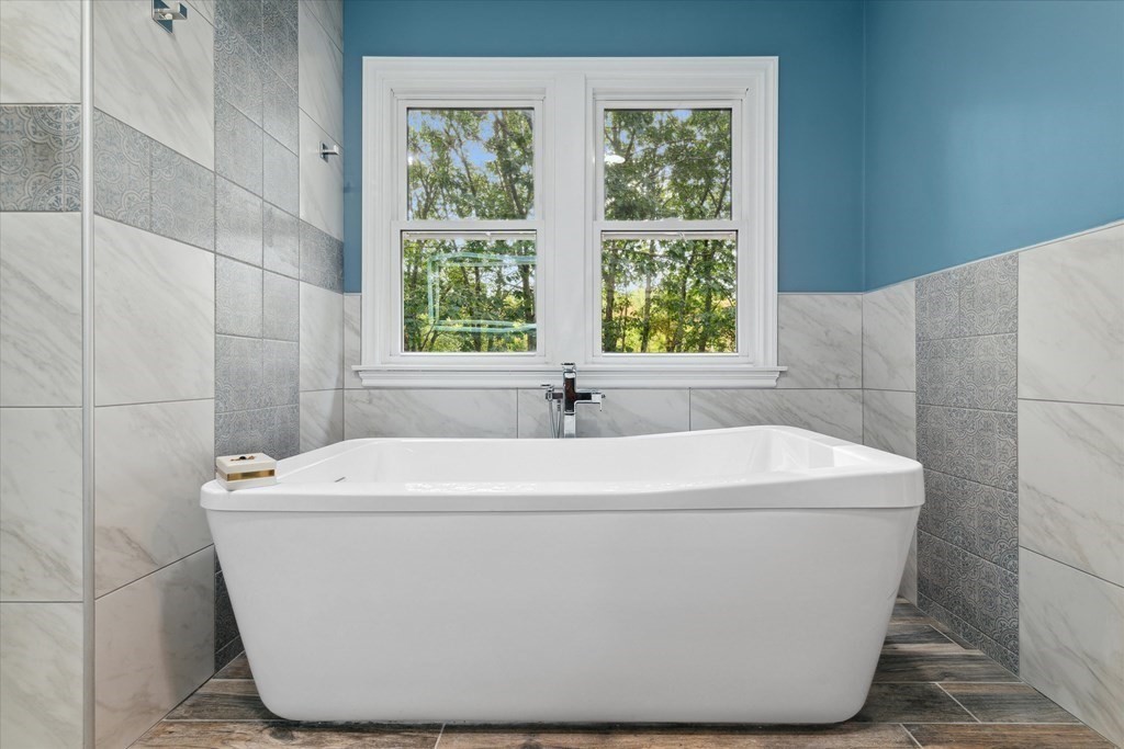 10 Fieldstone Way Boxford, MA 01921 - Photo 24 of 42 a white bath tub sitting in a bathroom