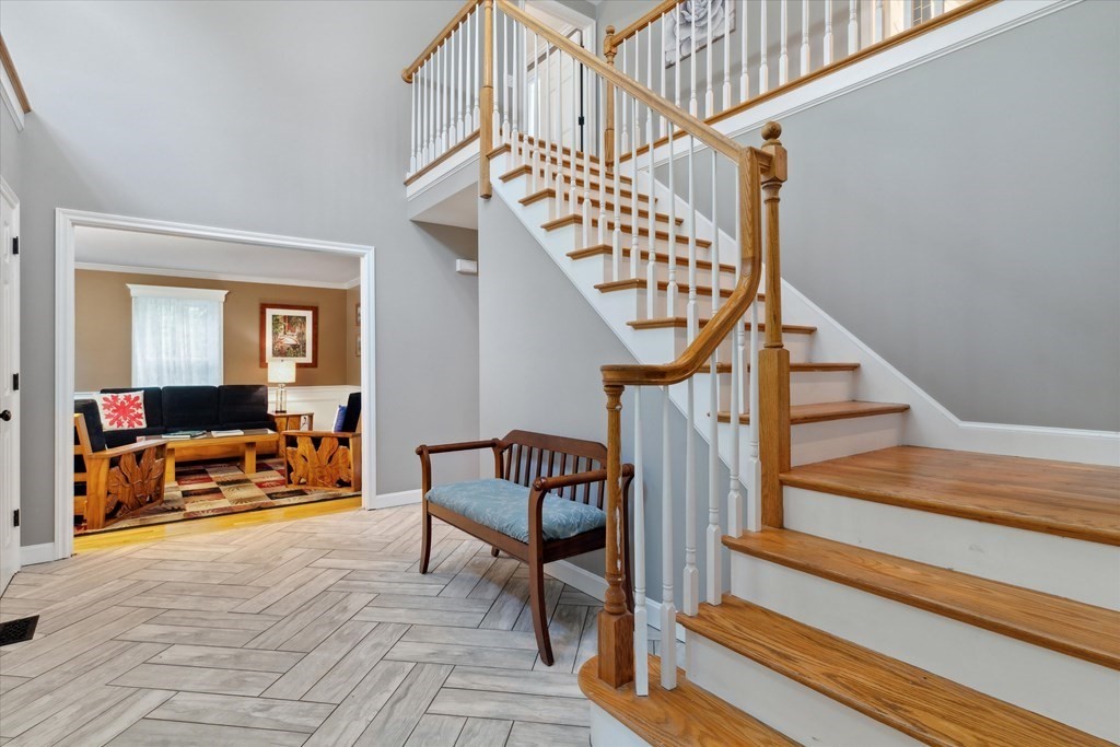 10 Fieldstone Way Boxford, MA 01921 - Photo 4 of 42 a living room with wooden floor stairs and a dining table