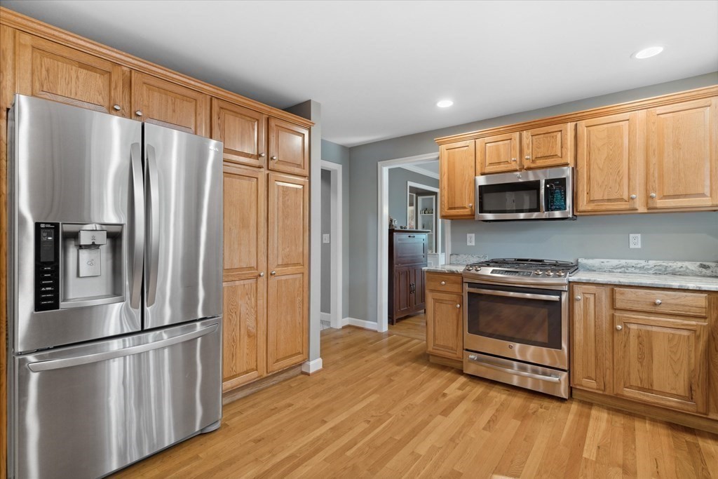 10 Fieldstone Way Boxford, MA 01921 - Photo 9 of 42 a kitchen with stainless steel appliances a refrigerator sink and microwave