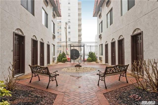 425 Shore Road, Unit 2C Long Beach, NY 11561 - Photo 1 of 1 a row of chairs and a table in the terrace