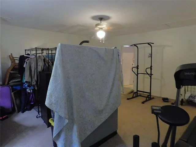 a room with furniture and a ceiling fan