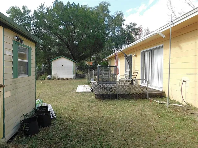 a backyard of a house with barbeque oven