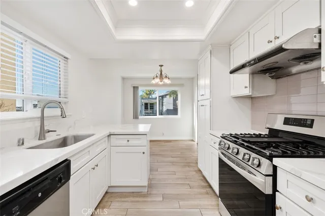 a kitchen with stainless steel appliances a sink dishwasher stove and refrigerator