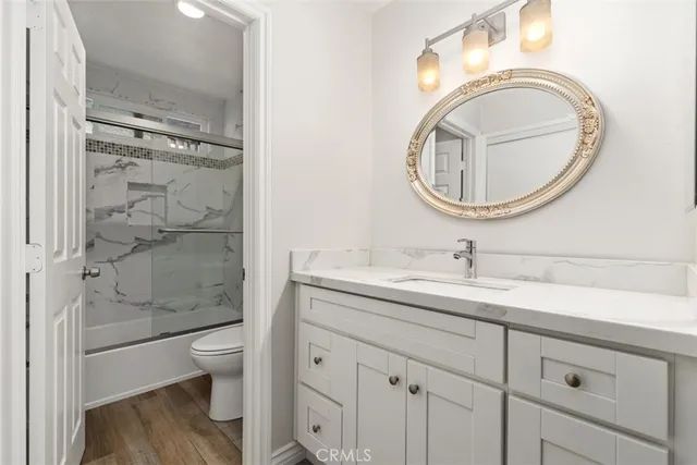 a bathroom with a granite countertop toilet sink and garden