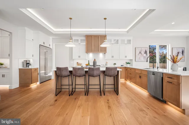 a large kitchen with stainless steel appliances lots of counter space and a sink
