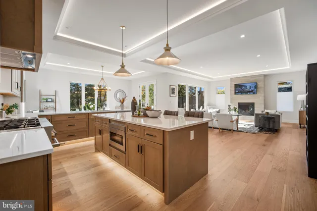 a dining room with wooden floor a chandelier a wooden table and chairs
