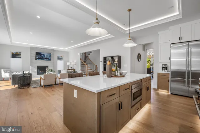 a view of a dining room kitchen and a chandelier