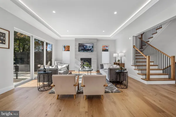 a living room with furniture kitchen view and a table