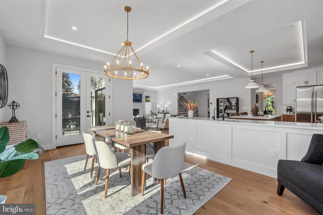 a living room with furniture kitchen view and a table