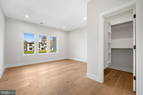 a spacious bedroom with a bed and furniture