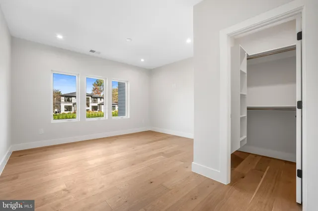 a spacious bedroom with a bed and furniture