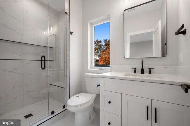 a view of an empty room with wooden floor and a cabinet