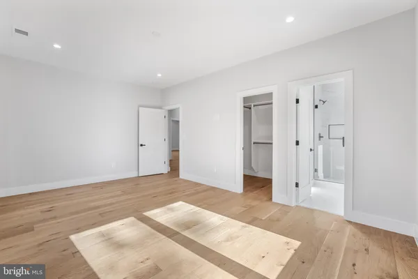 a bathroom with a toilet a sink a mirror and vanity