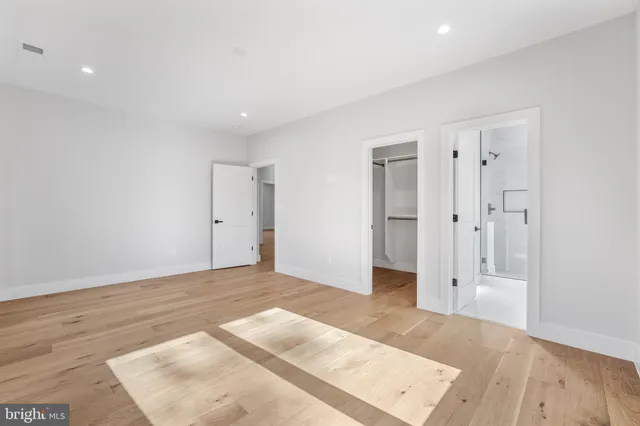 a bathroom with a toilet a sink a mirror and vanity