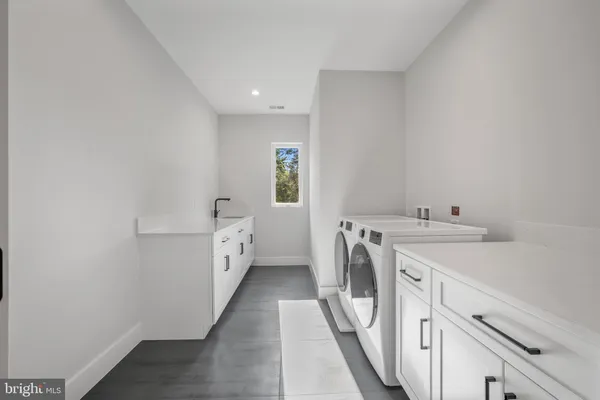 a view of a house with a big yard potted plants and large tree