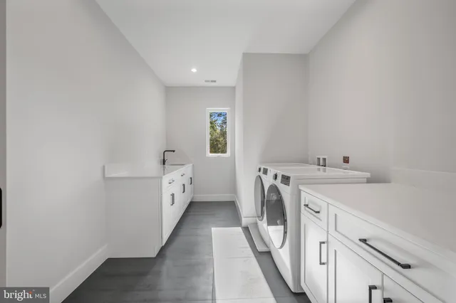 a view of a house with a big yard potted plants and large tree