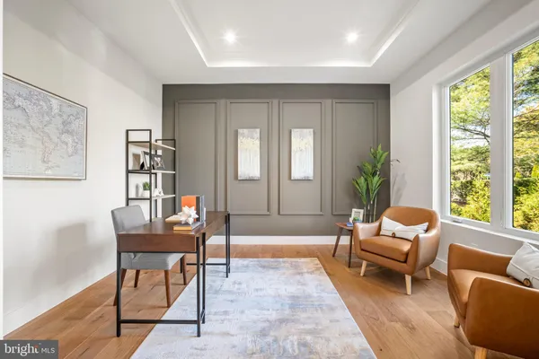 a large kitchen with cabinets wooden floor white stainless steel appliances and dining table