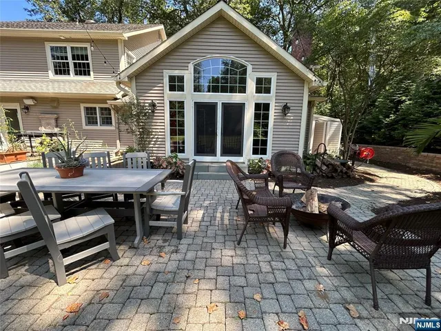 a view of a house with backyard and sitting area
