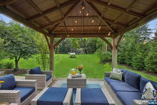 a view of a patio with couches chairs and a yard