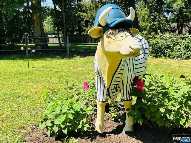 a backyard of a house with lots of green space and fountain