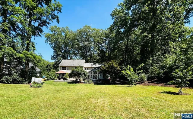 a view of a swimming pool with lawn chairs under an umbrella